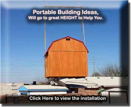 Lifting a portable storage building over a wall to deliver to a customers home